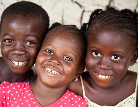 three kids smiling into camera