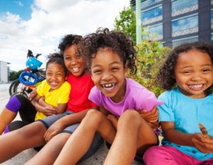 kids laughing at camera sitting down